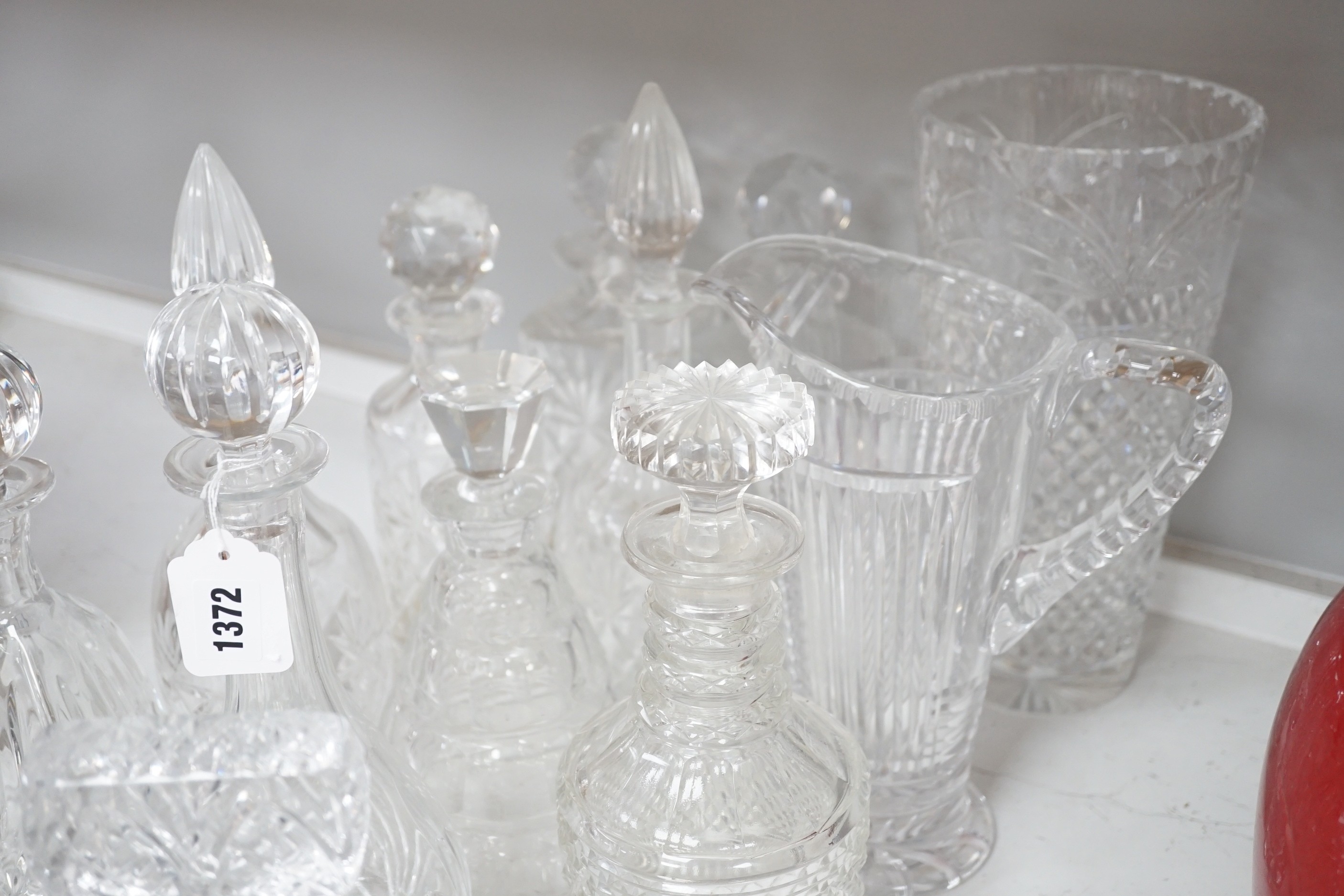 A group of assorted glass decanters and two vases